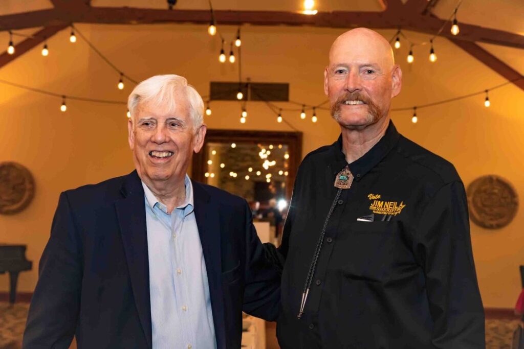 Sheriff Jim Neil and a supporter at a campaign event.